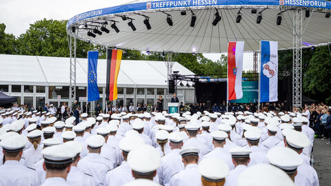 Eine Gruppe von Menschen in weißen Hemden und mit weißen Mützen.